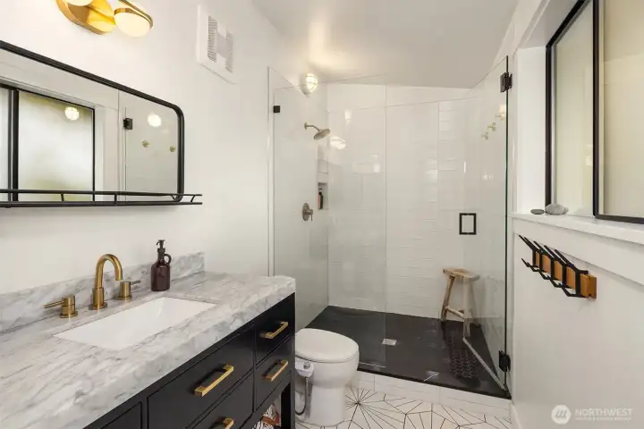 Stylishly remodeled primary bathroom with designer marble & tile finishes.