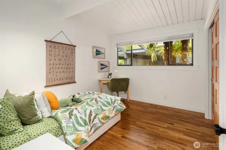 The second bedroom also features vaulted ceilings.