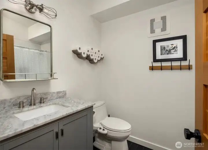 Full remodeled bathroom with tub off the hallway.