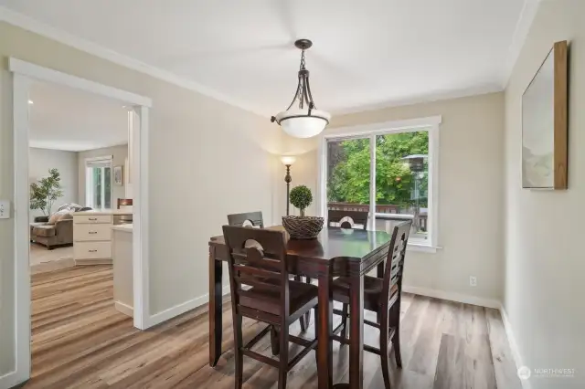 Formal dining area with lots of light and wide plank floors.