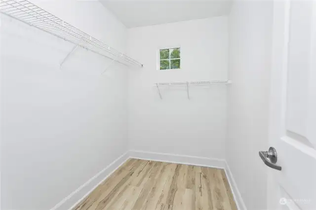 Primary walk in closet, plenty of room for everything