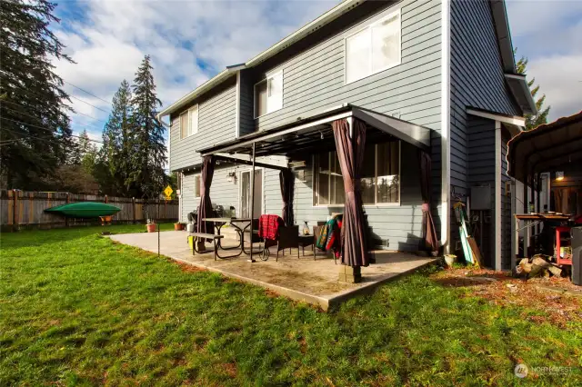 Large patio ideal for grilling. The pergola provides coverage all year - a great spot for a hot tub, with all the connections in place. Covered work area in the side yard.