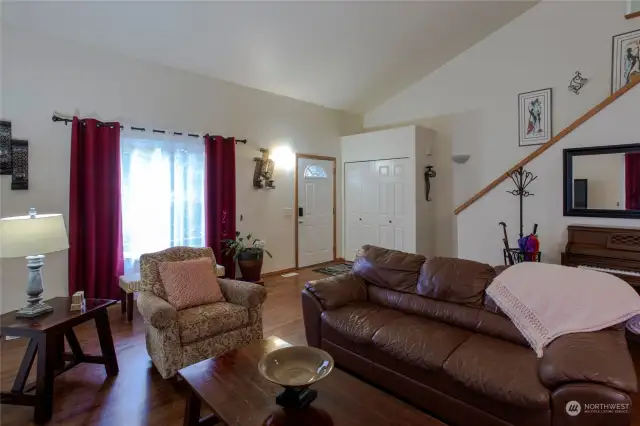 Living room, entry, entry coat closet, and the staircase.