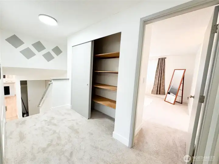 Upper landing area has ample closet storage