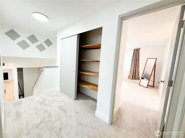 Upper landing area has ample closet storage