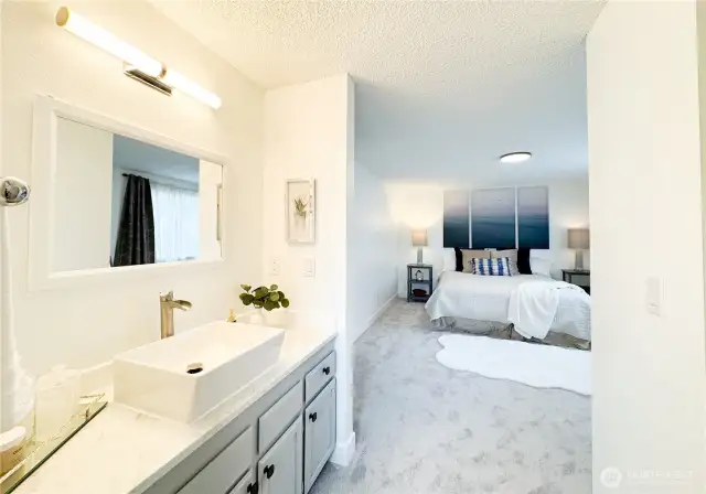 Primary bedroom has it's own remodeled bathroom and a walking closet to the right.