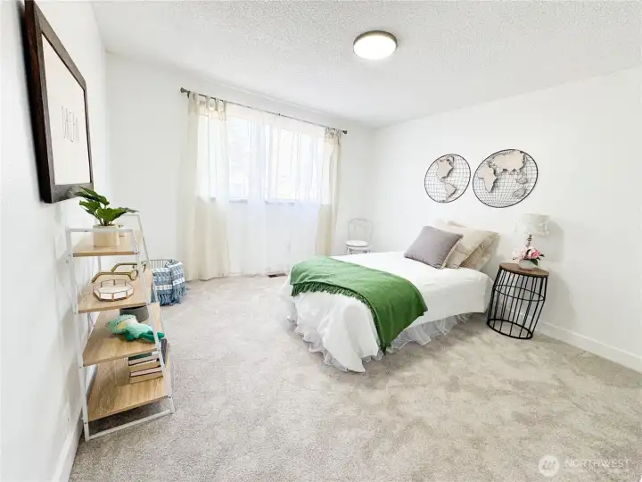 Second bedroom with new carpet and paint ready is so large that it can easily fit a king-size bed.