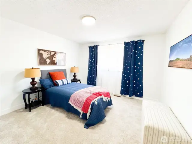 The third bedroom has fresh paint, clean carpet, natural light, and is well-sized for a full bed.