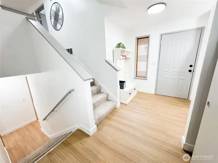 Entry area is well lit, has a large coat closet to the right, and leads to additional bonus area, laundry room, bathroom and garage.