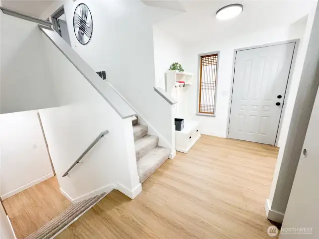 Entry area is well lit, has a large coat closet to the right, and leads to additional bonus area, laundry room, bathroom and garage.