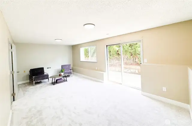 The large bonus/family room area has new carpet and paint. It connects with the patio area.