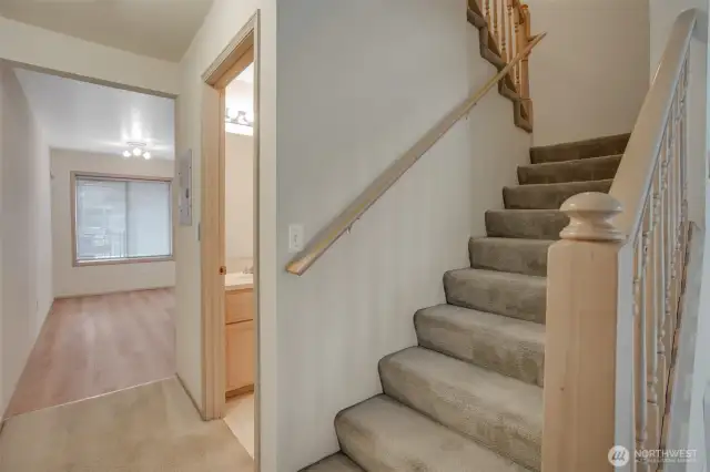 The staircase to upper level where two bedrooms and bathroom are located.