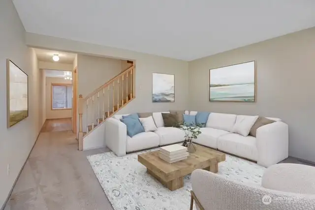 Upon your entry into the home, you are greeted by a fresh living space with neutral tones. This photo has been virtually staged.