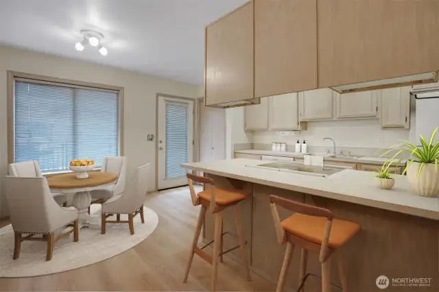A well-functioning kitchen offers eat in kitchen dining, bar counter seating and loads of cabinetry space. This photo has been virtually staged.