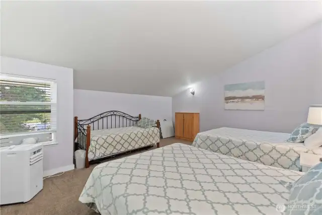 Upper level loft with 3 beds.
