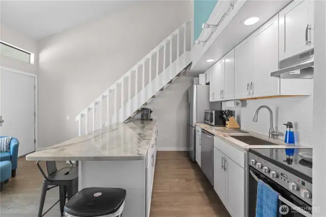 Kitchen w/new cabinetry, countertops, and SS appliances.