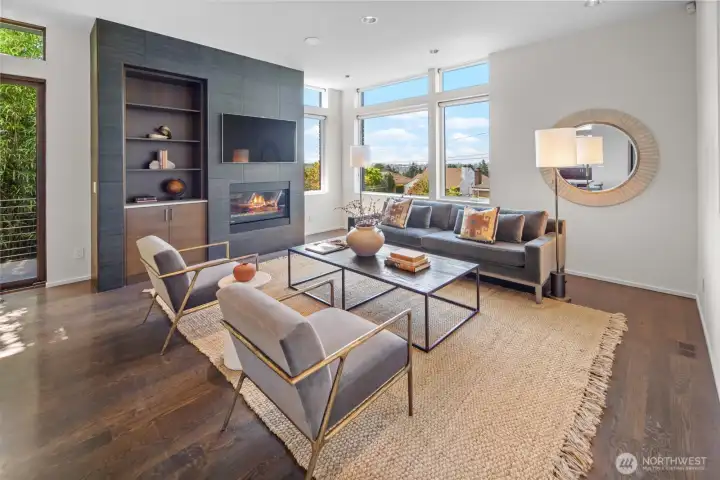 Living room featuring gas fireplace and western views across the neighborhood towards the Olympics and even Green Lake and Downtown Seattle