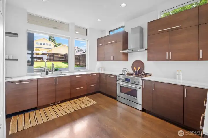 Kitchen with sink overlooking the back deck and professional JennAir gas range