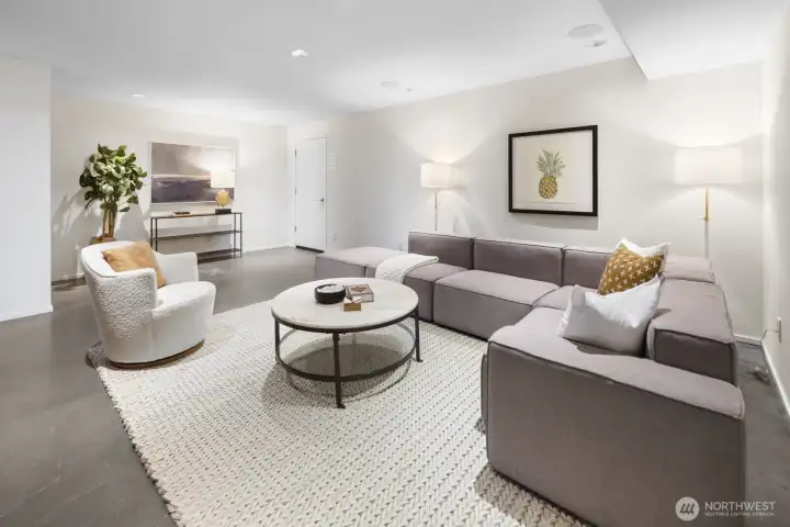Exceptional rec room/media room, featuring radiant-heated polished concrete floors, built-in cabinets and shelving, and 5.1 surround sound