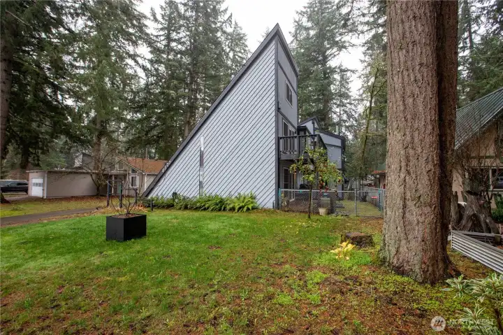 Another angle of the home, there is a deck that comes out from the dining area and another one upstairs just off of the loft.