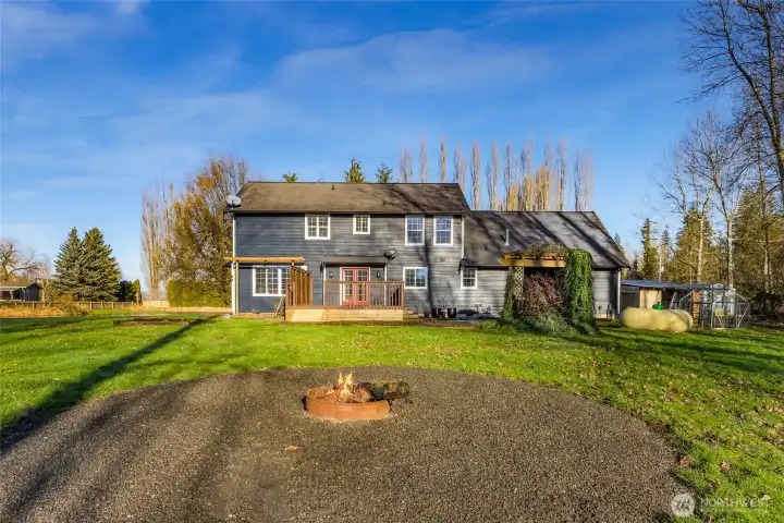 The wide, freshly graveled driveway provides easy access and generous parking, ideal for daily use, guests, and equipment. Open surroundings reinforce the privacy and space this nearly 10-acre property provides.