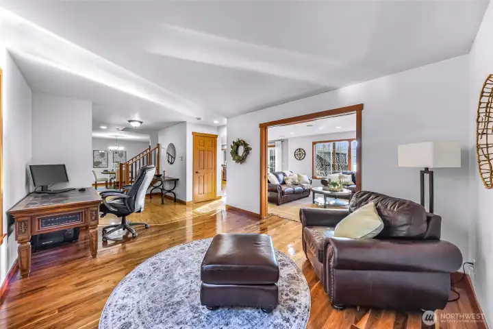 Open-concept living space showcases warm finishes and seamless flow between kitchen, dining, and living areas. Designed for comfort and functionality, this layout adapts easily to both entertaining and quiet evenings at home.