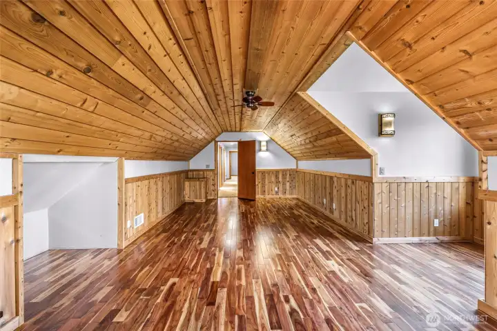 Bonus or recreation space with wood ceiling creates a warm, lodge-like atmosphere. Perfect for hobbies, fitness, or entertaining.