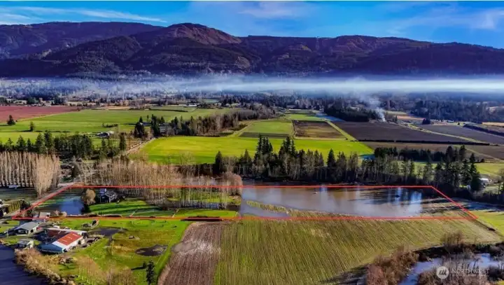 Aerial view outlines property boundaries and shows the elevated homesite. Notably, the area surrounding the home remained dry during recent December and January atmospheric river events.