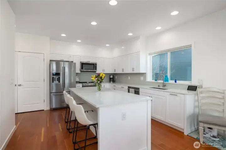 View of kitchen as you stand in the middle of the open concept floor plan on the main level.