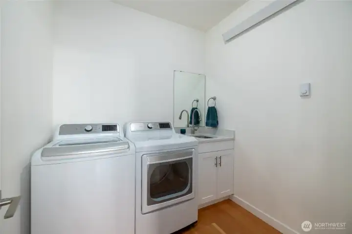 Power room/utility room conveniently located just outside the primary bedroom adjacent to living rom on main level.