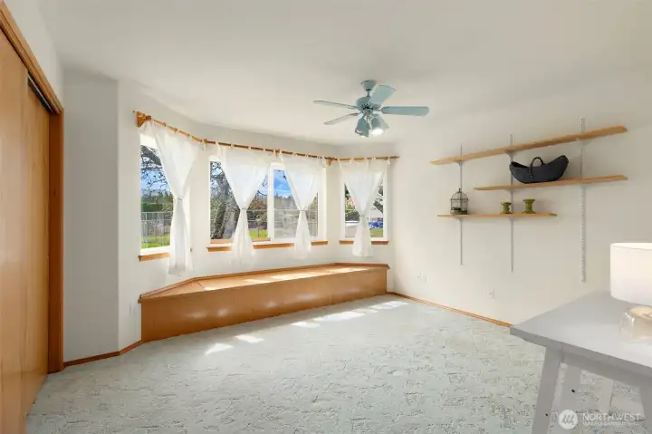 Bedroom with built in storage bench and a view of the mountains