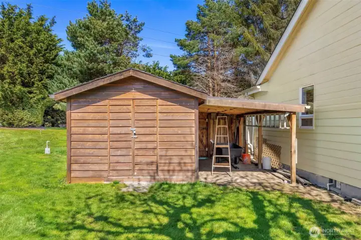 Extra storage in custom built shed with covered area.