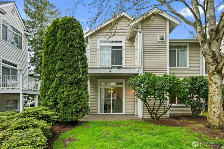 Open yard area just outside patio for recreation or relaxation.