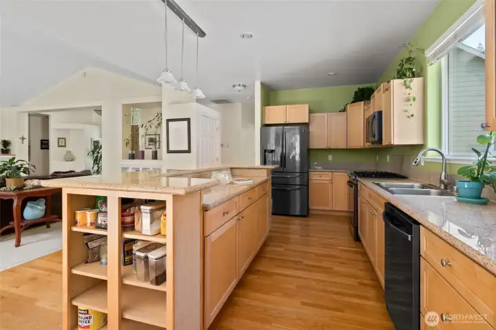 Kitchen with granite countertops, stainless steel appliances, and hardwood floors.