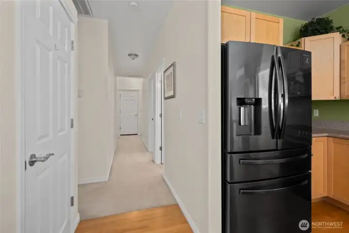 Door to the left is a pantry. Hall leads to bathroom, laundry room, stairs to bonus room, and garage.