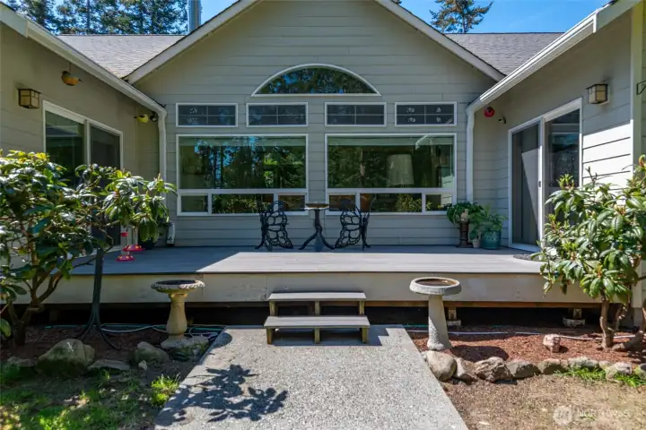 Spacious back deck with sliding glass doors to dining room and primary bedroom.