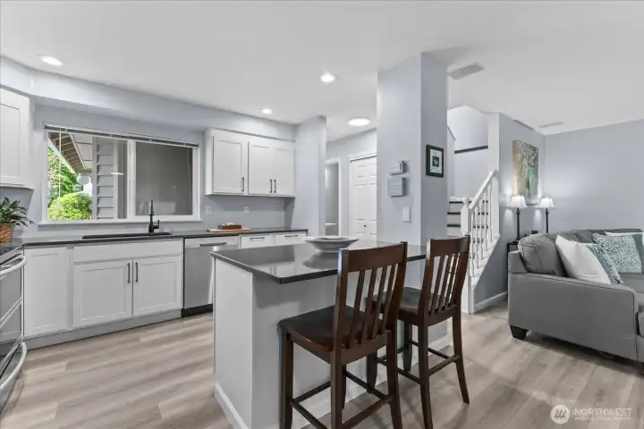 Beautifully renovated kitchen now features an open-concept layout and a breakfast bar with seating for two. Beautifully renovated kitchen now features an open-concept layout and a breakfast bar with seating for two.