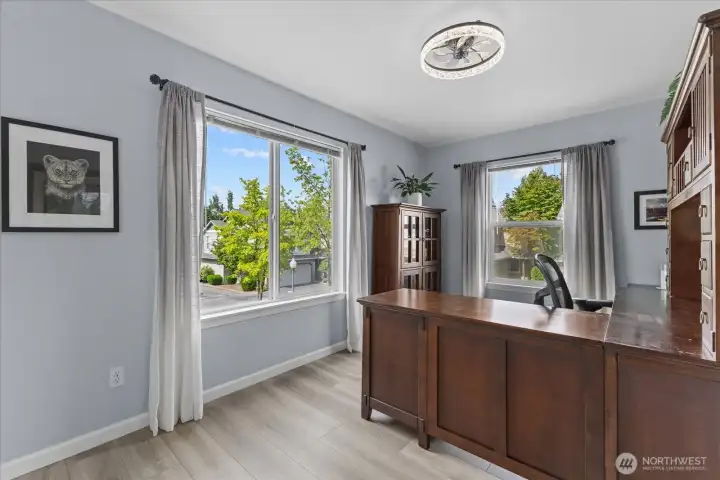The corner bedroom is currently staged as a light-filled home office, offering a bright and productive workspace. The corner bedroom is currently staged as a light-filled home office, offering a bright and productive workspace.