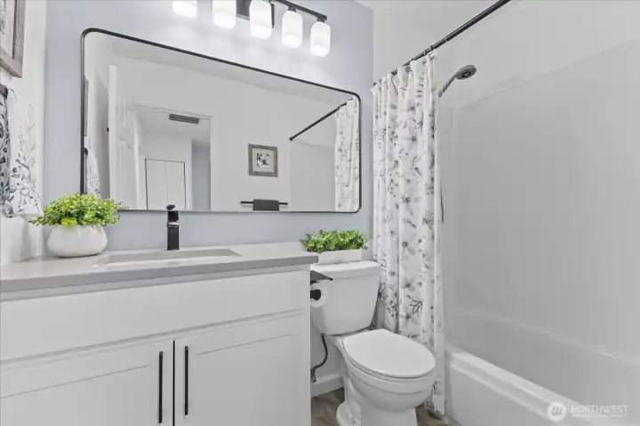 Upstairs full bathroom featuring premium finishes and modern amenities. Upstairs full bathroom featuring premium finishes and modern amenities.