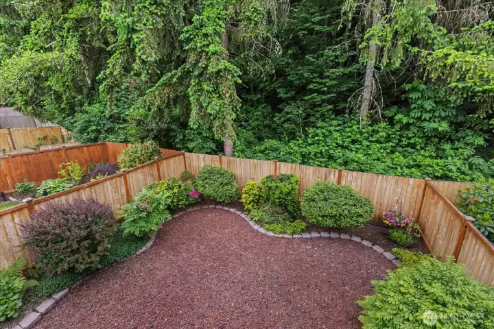 Fully fenced, larger yard with lots of perennials. Southwest facing toward the native growth area Fully fenced, larger yard with lots of perennials. Southwest facing toward the native growth area
