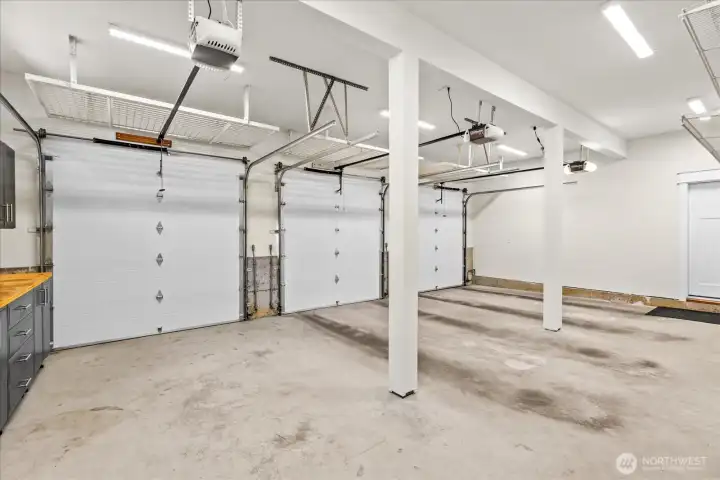 Garage with generous shelving and ceiling storage Garage with generous shelving and ceiling storage