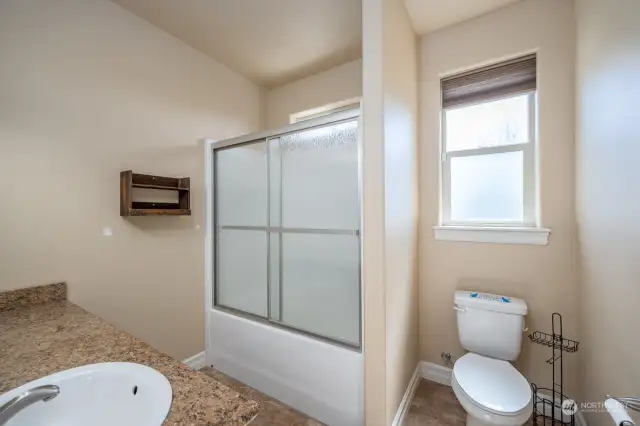 This is the main bathroom with tub shower combo. The current owners had the doors installed as they didn't come with the home when they bought it.