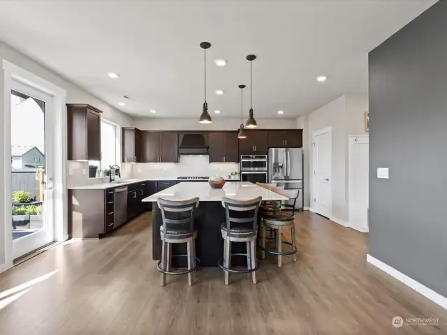 Boasting sleek sophistication, the chef's kitchen features exquisite slab quartz aounters, complemented perfectly by the convenience of a gas cook top and a designated wine bar, setting the stage for culinary excellence and entertaining alike.