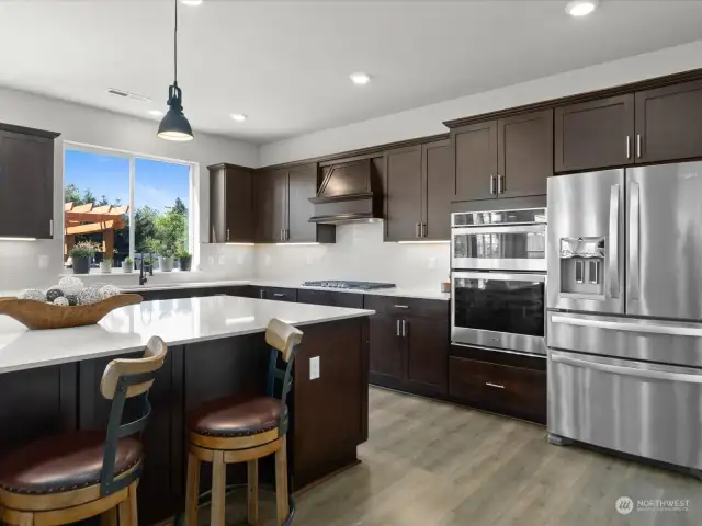 Equipped with top-of-the-line stainless steel appliances, including a sleek cooktop and oven, this kitchen is a chef's dream come true. From gourmet meals to casual snacks, every culinary creation is made effortless in this well-appointed space.