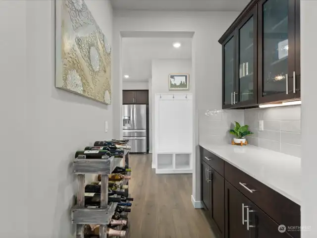 Complementing the main kitchen area is a sophisticated butler's pantry or wine bar, adding an extra touch of elegance and functionality to the home.