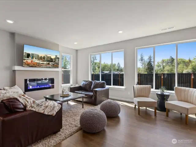 Welcome to the heart of the home, where luxury meets comfort in the expansive great room boasting a magnificent wall of windows that frames picturesque views of the backyard.