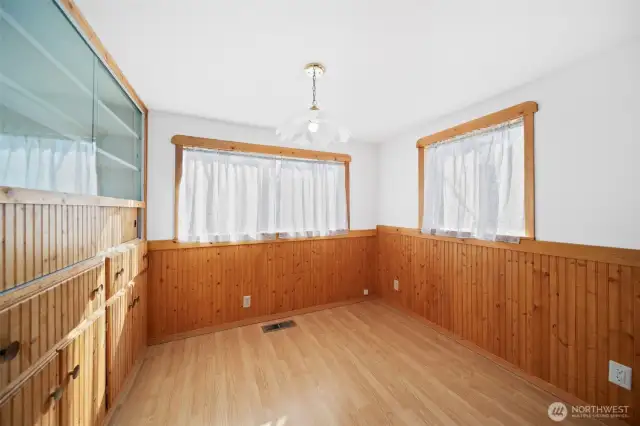 Dining room with adorable wainscotting and lots of storage.