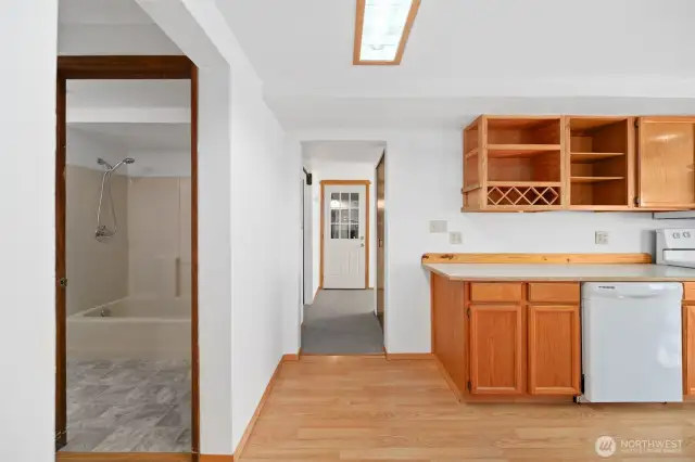 Full bathroom on main floor (to the left), garage door straight ahead and kitchen to the right.