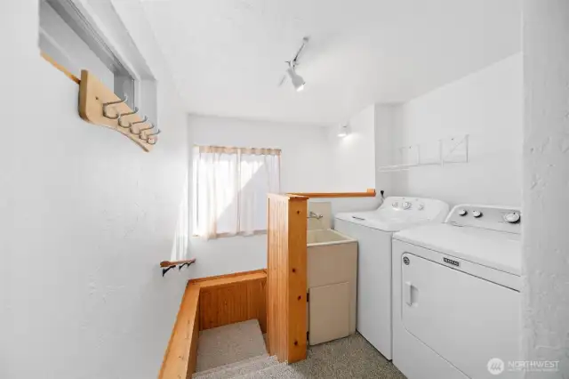 Laundry on main floor, with new flooring. Stairs to basement to the left.