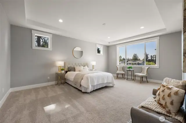 The capacious and luxurious primary suite is located on main level, and includes its own private ensuite and large walk-in wardrobe.